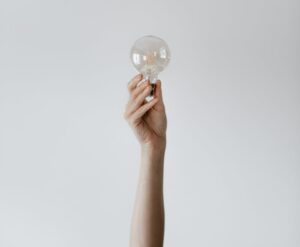 Anonymous female showing light bulb